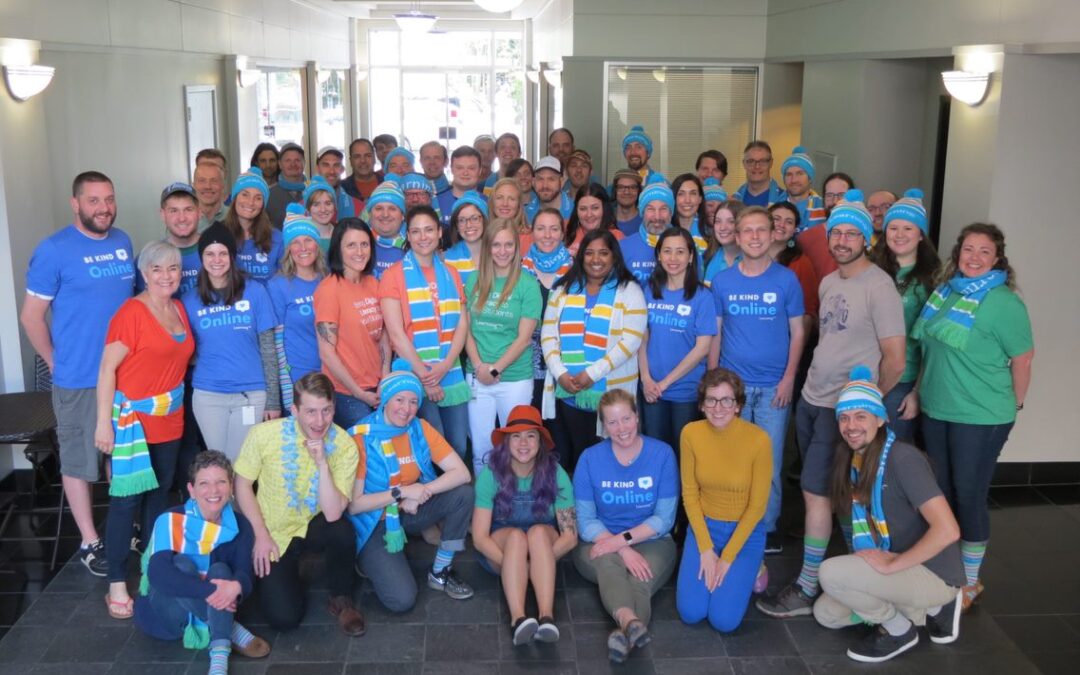 learning.com team in group together wearing scarves and hats