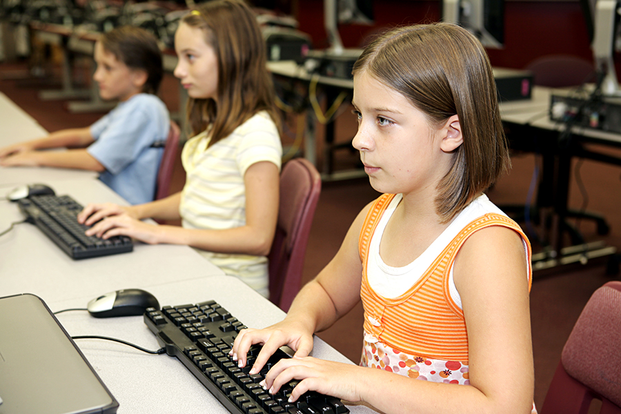 Middle School Age Students Practicing Keyboarding Skills at School