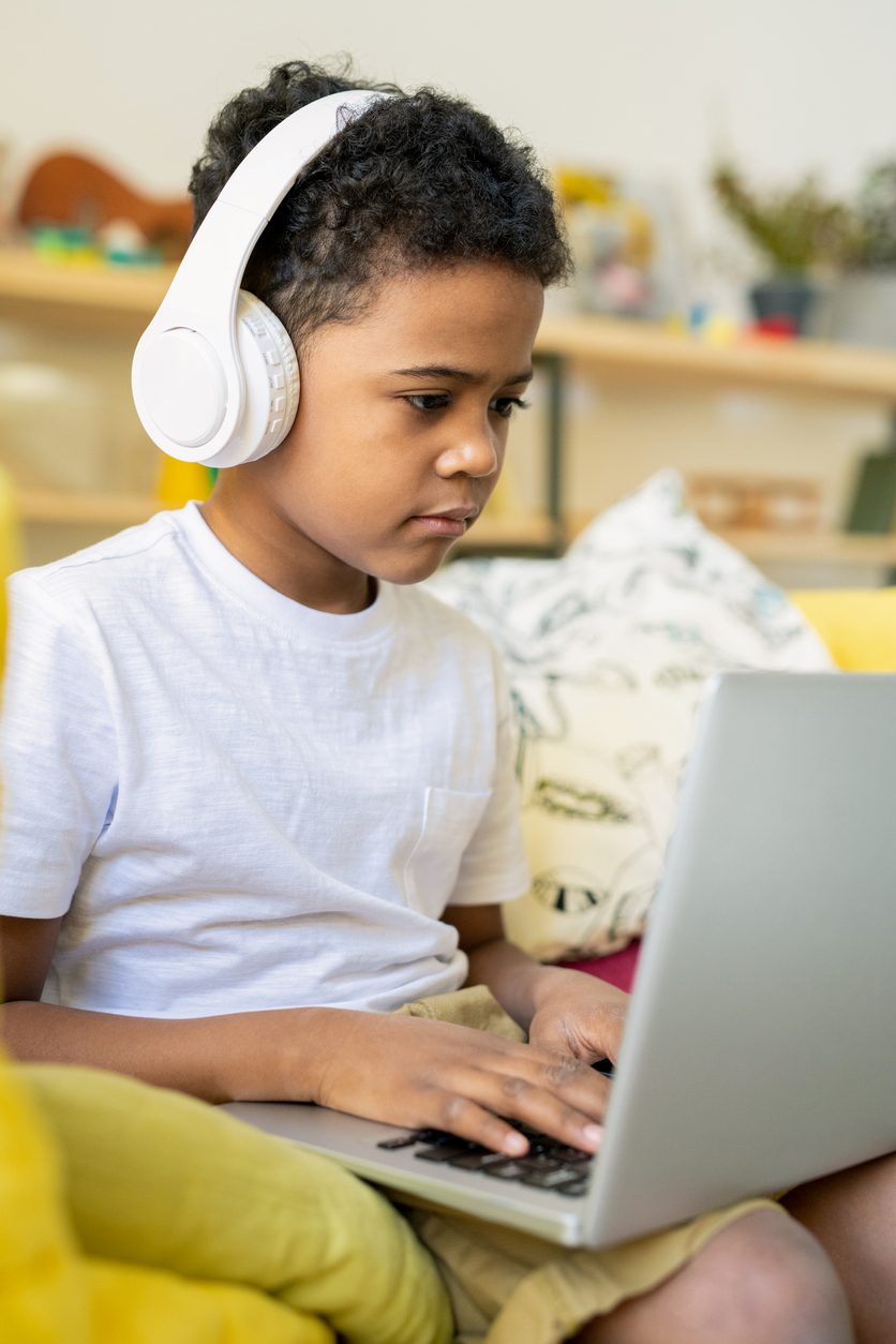 Elementary student on laptop practicing computational thinking skills