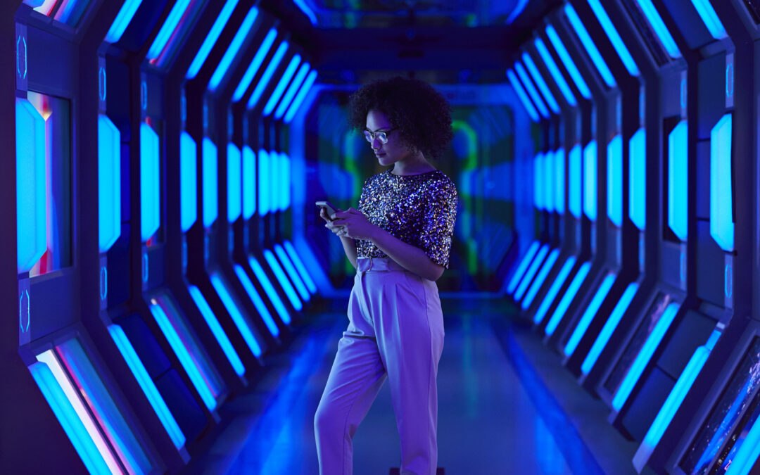 Young female entrepreneur on smartphone in futuristic tunnel symbolizing future career