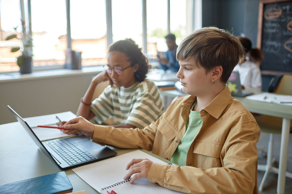 Two students working together in a classroom on AI lessons